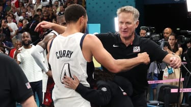 PARIS, FRANCE - AUGUST 08: Stephen Curry #4 and Head coach Steve Kerr of Team United States hug after winning a Men's basketball semifinals match between Team United States and Team Serbia on day thirteen of the Olympic Games Paris 2024 at Bercy Arena on August 08, 2024 in Paris, France. (Photo by Ezra Shaw/Getty Images)