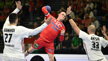 Norway's center back Tobias Grondahl (C) shoots and scores a goal past Hungary's pivot Bence Banhidi (L) and Hungary's right back Gabor Ancsin during the men's Handball Olympic qualifying match between Norway and Hungary in Tatabanya, Hungary on March 16, 2024. (Photo by ATTILA KISBENEDEK / AFP) (Photo by ATTILA KISBENEDEK/AFP via Getty Images)