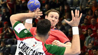 Norway's center back Sander Sagosen (R) and Portugal's left back Alexandre Cavalcanti  vie for the ball during the men's Handball Olympic qualifying match between Norway and Portugal in Tatabanya, Hungary on March 14, 2024. (Photo by ATTILA KISBENEDEK / AFP) (Photo by ATTILA KISBENEDEK/AFP via Getty Images)