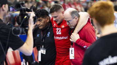 Switzerland's Jonas Schelker, center, gets escortet to the wardrobe as he receives medical treatment during the 50. Yellow Cup Handball game between Switzerland and Argentina on Saturday, January 6, 2024 in Winterthur, Switzerland. (KEYSTONE/Ron Buholzer).