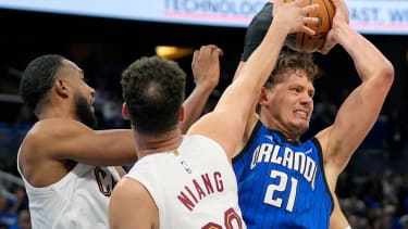 Orlando Magic center Moritz Wagner (21) grabs an offensive rebound away from Cleveland Cavaliers forward Evan Mobley, left, and forward Georges Niang during the second half of Game 6 of an NBA basketball first-round playoff series, Friday, May 3, 2024, in Orlando, Fla. (AP Photo/John Raoux)