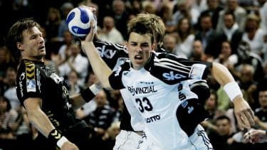 Dominik Klein of THW Kiel is about to hurl the ball as Johnny Jensen, left, of SG Flensburg-Handewitt, left,during Handball Champions League 2nd leg final match in Kiel, northern Germany, on Sunday, April 29, 2007. The 1st leg final match ended in a 28-28 draw. (AP Photo/Heribert Proepper)