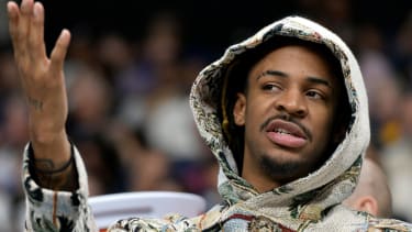 Memphis Grizzlies guard Ja Morant speaks with teammates on the bench in the first half of an NBA basketball game against the Denver Nuggets Sunday, April 14, 2024, in Memphis, Tenn. (AP Photo/Brandon Dill)