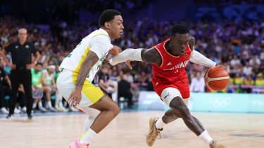 LILLE, FRANCE - JULY 30: Dennis Schroder #17 of Team Germany drives past Yago Santos #2 of Team Brazil during a Men's Group Phase-Group B match between Brazil and Germany on day four of the Olympic Games Paris 2024 at Stade Pierre Mauroy on July 30, 2024 in Lille, France. (Photo by Gregory Shamus/Getty Images)