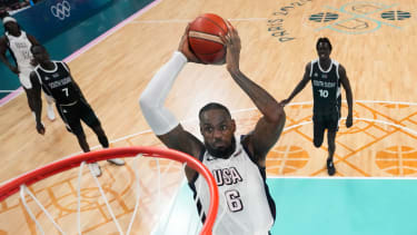 LeBron James, of the United States, goes up for a dunk against South Sudan in a men's basketball game at the 2024 Summer Olympics, Wednesday, July 31, 2024, in Villeneuve-d'Ascq, France. (AP Photo/Mark J. Terrill, Pool)